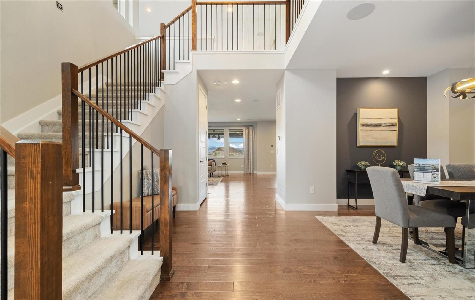 Two-story foyer with a staircase and wood floors in an Anthem Highlands home.