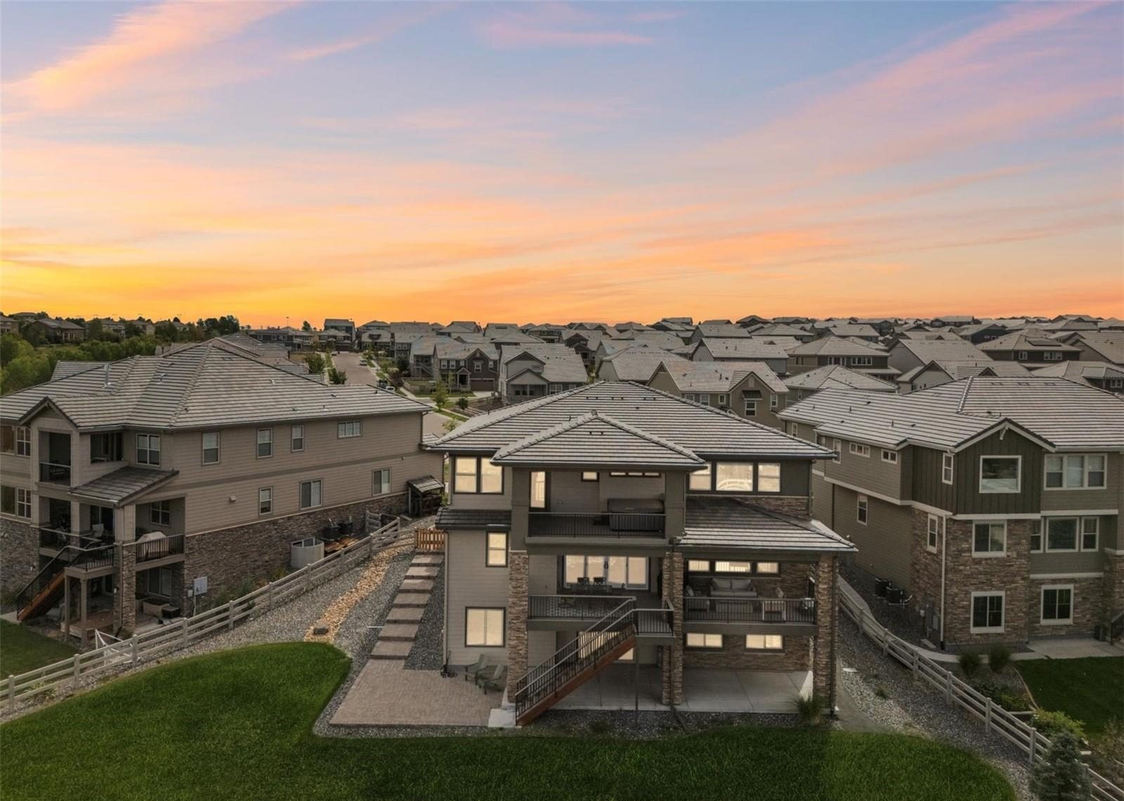 Aerial view over Anthem Highlands in north Broomfield at sunset, with the Front Range on the horizon.