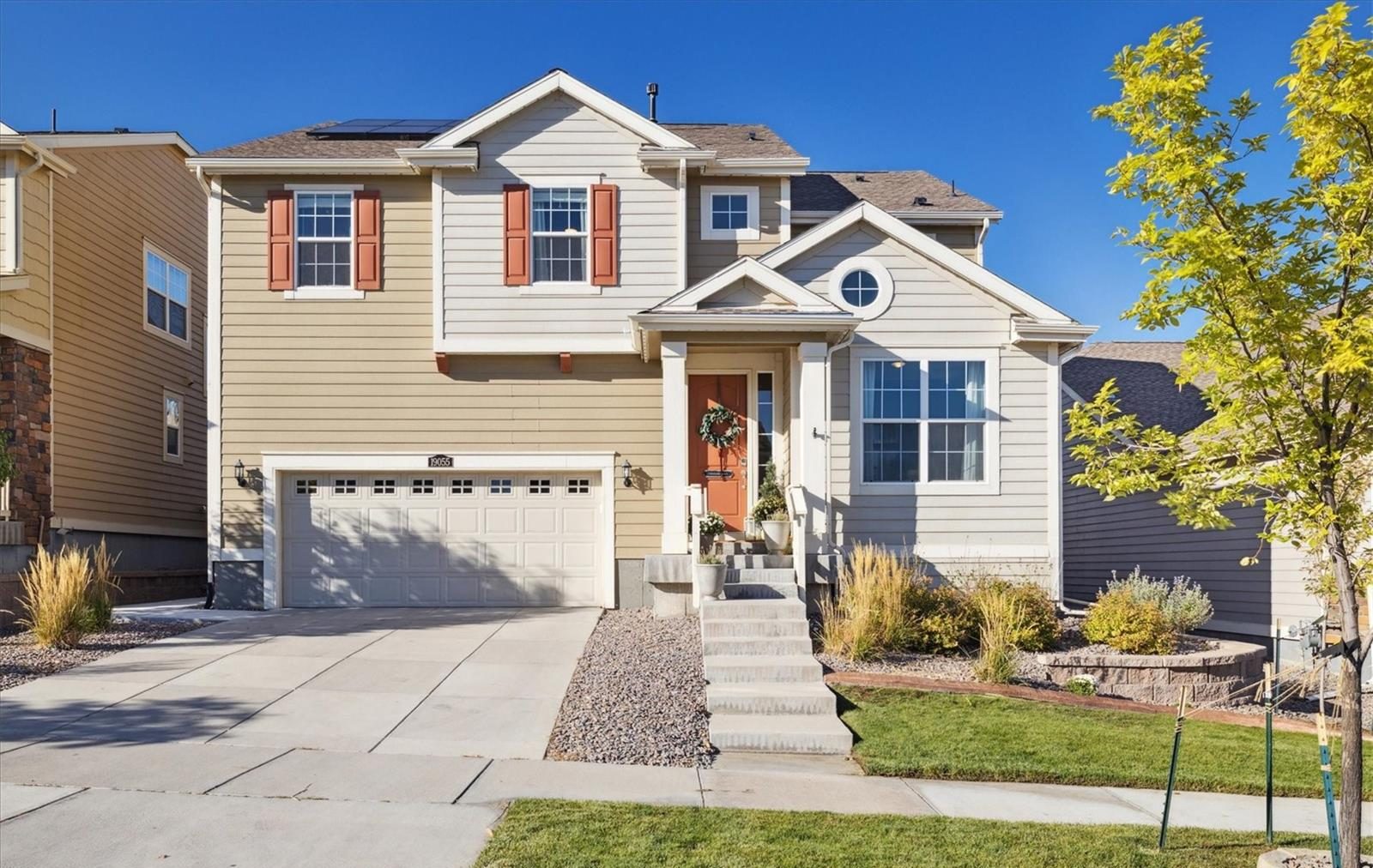 Two-story home with a covered porch in west Arvada on a sunny day.