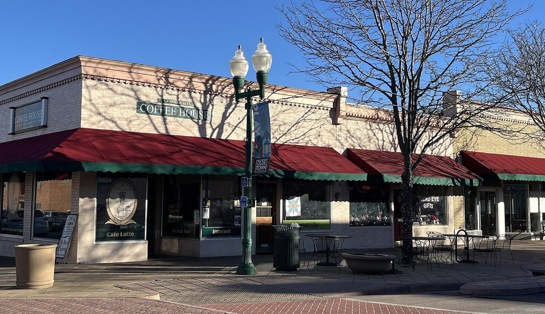 Storefronts with red awnings in Olde Town Arvada.