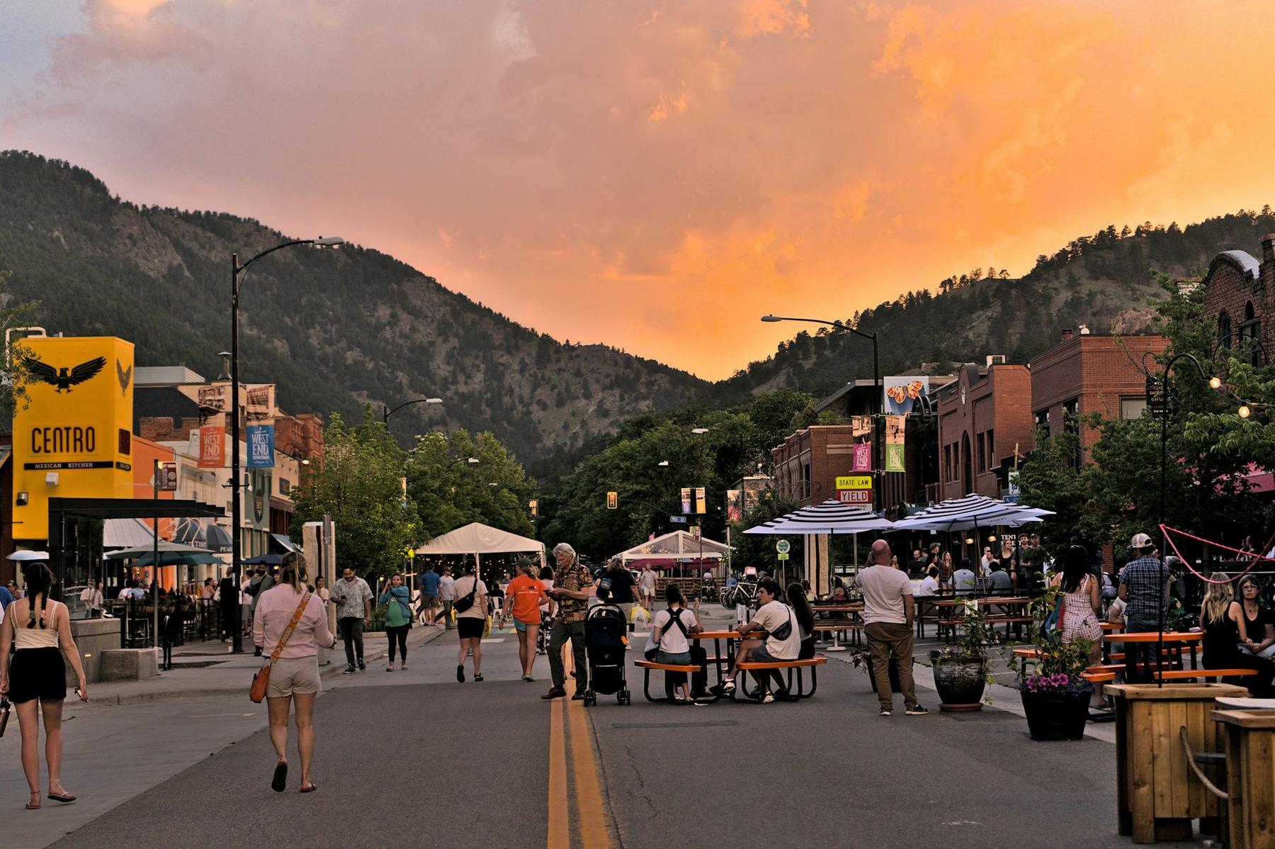 Pearl Street in Boulder at sunset, with the foothills beyond.