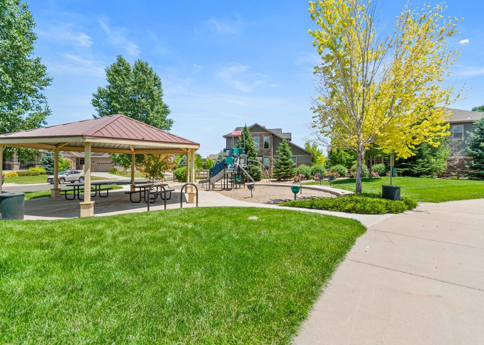 Park pavilion and playground beside a walking path in a Broomfield neighborhood.