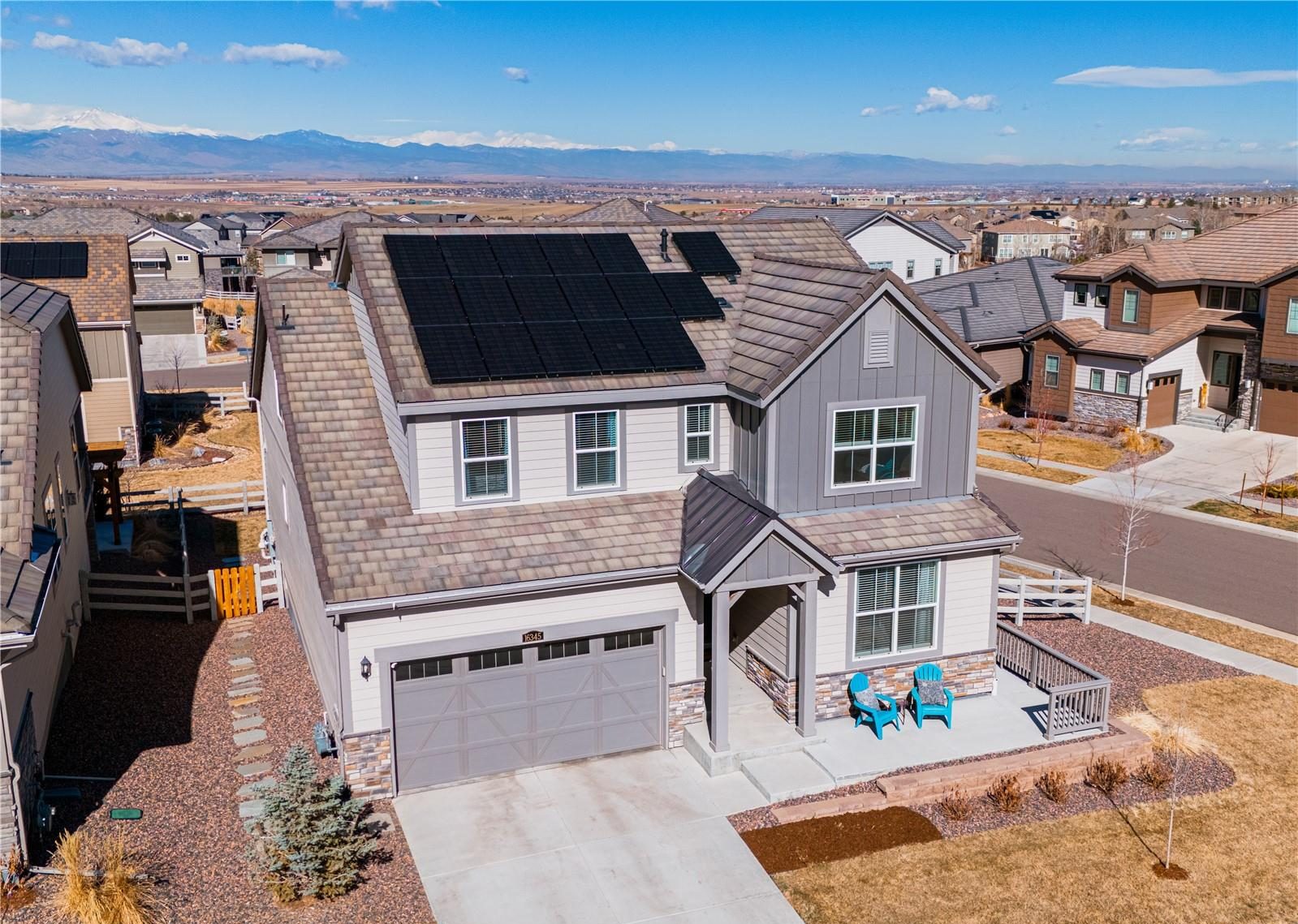 Aerial view of a new two-story home in Anthem Highlands, with the neighborhood and the Front Range beyond.