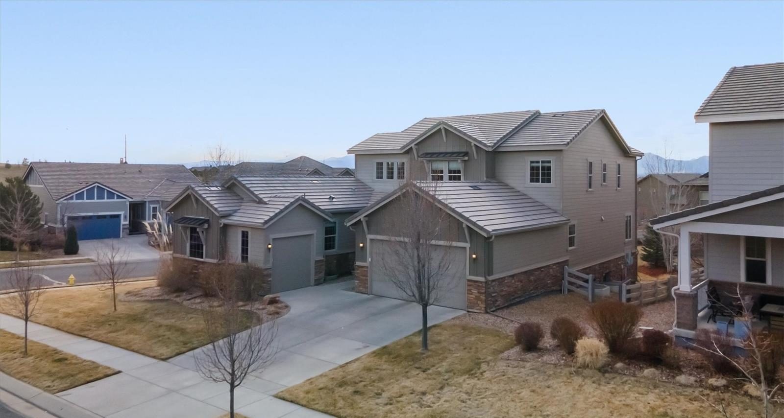 A street of two-story homes in Anthem Highlands on a clear day.