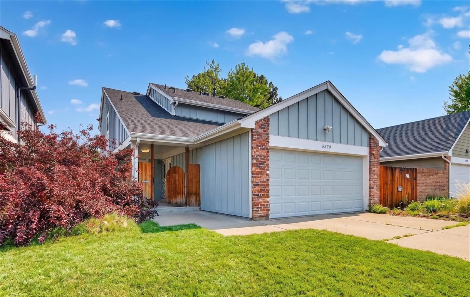 Single-family home with a blue-gray garage in Arvada.