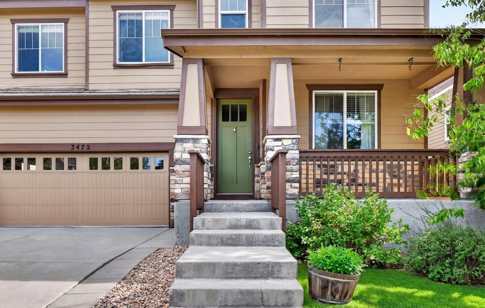 Covered front porch with a green door in Broomfield.