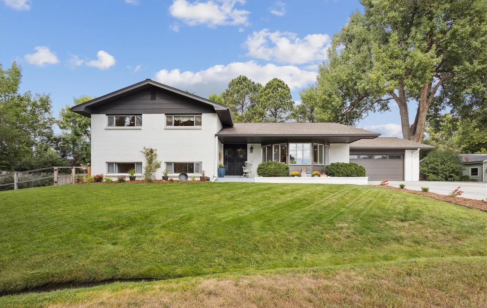 Mid-century home with a wide front lawn.