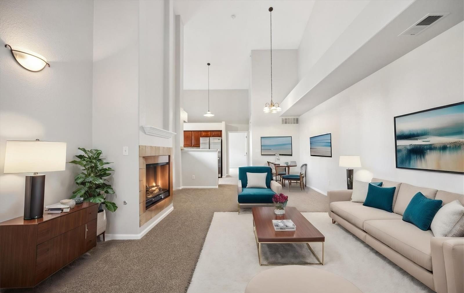 Staged living room in a condo with a fireplace.