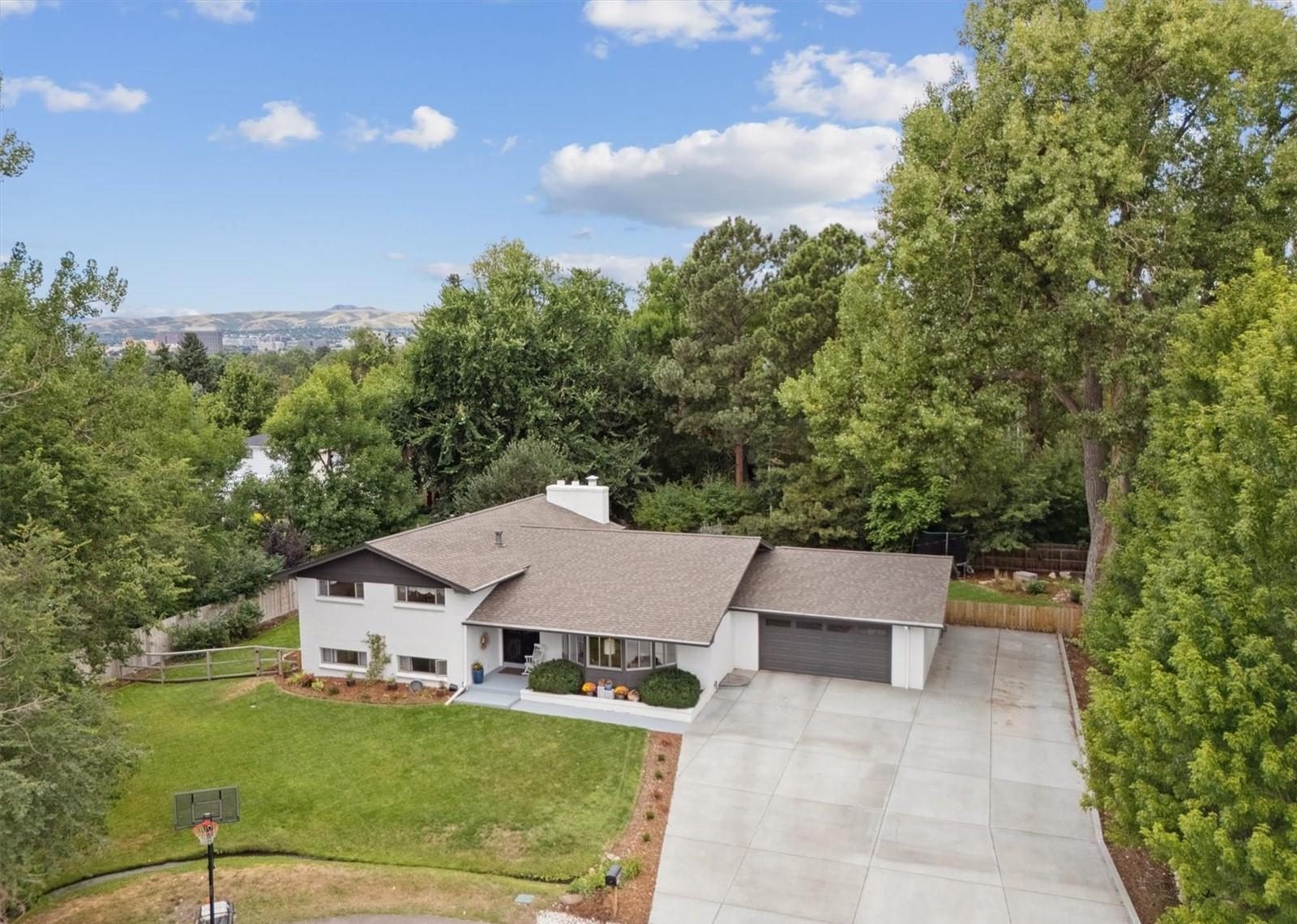 Aerial view of a mid-century home with mountains in the distance.