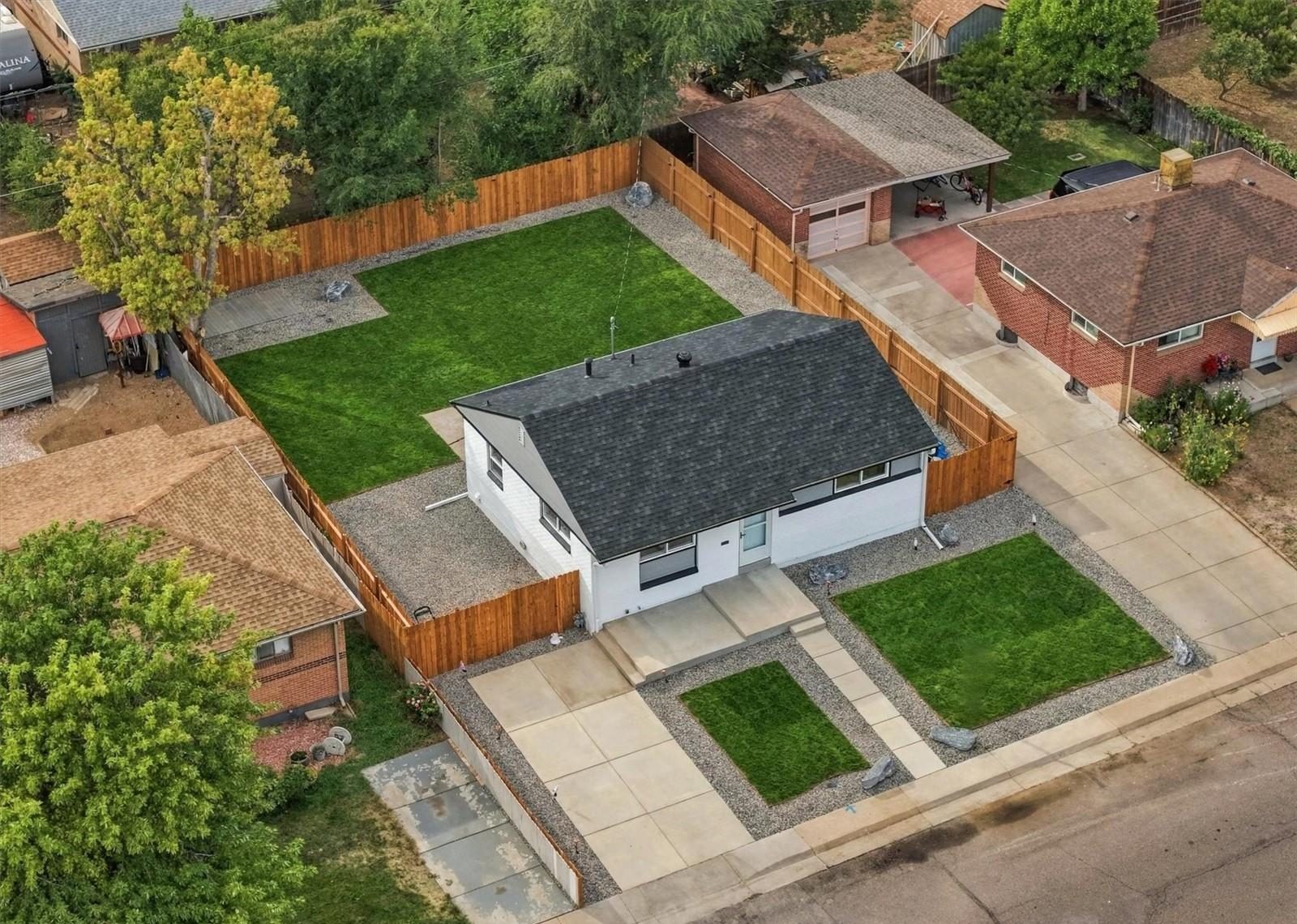 Aerial view of a renovated Denver home and its fenced yard.