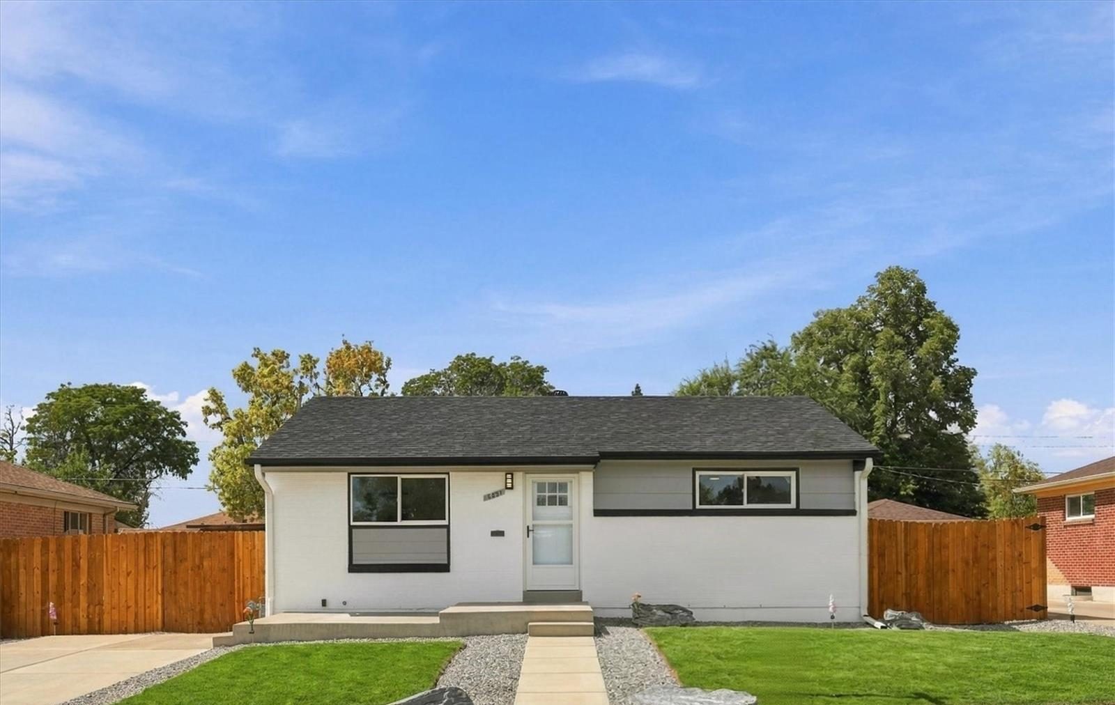 Renovated ranch-style home with a new fence in Denver.