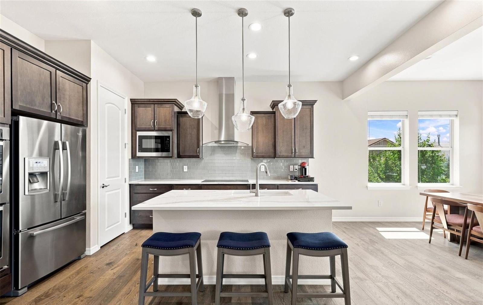 Kitchen with dark cabinets and a white island.