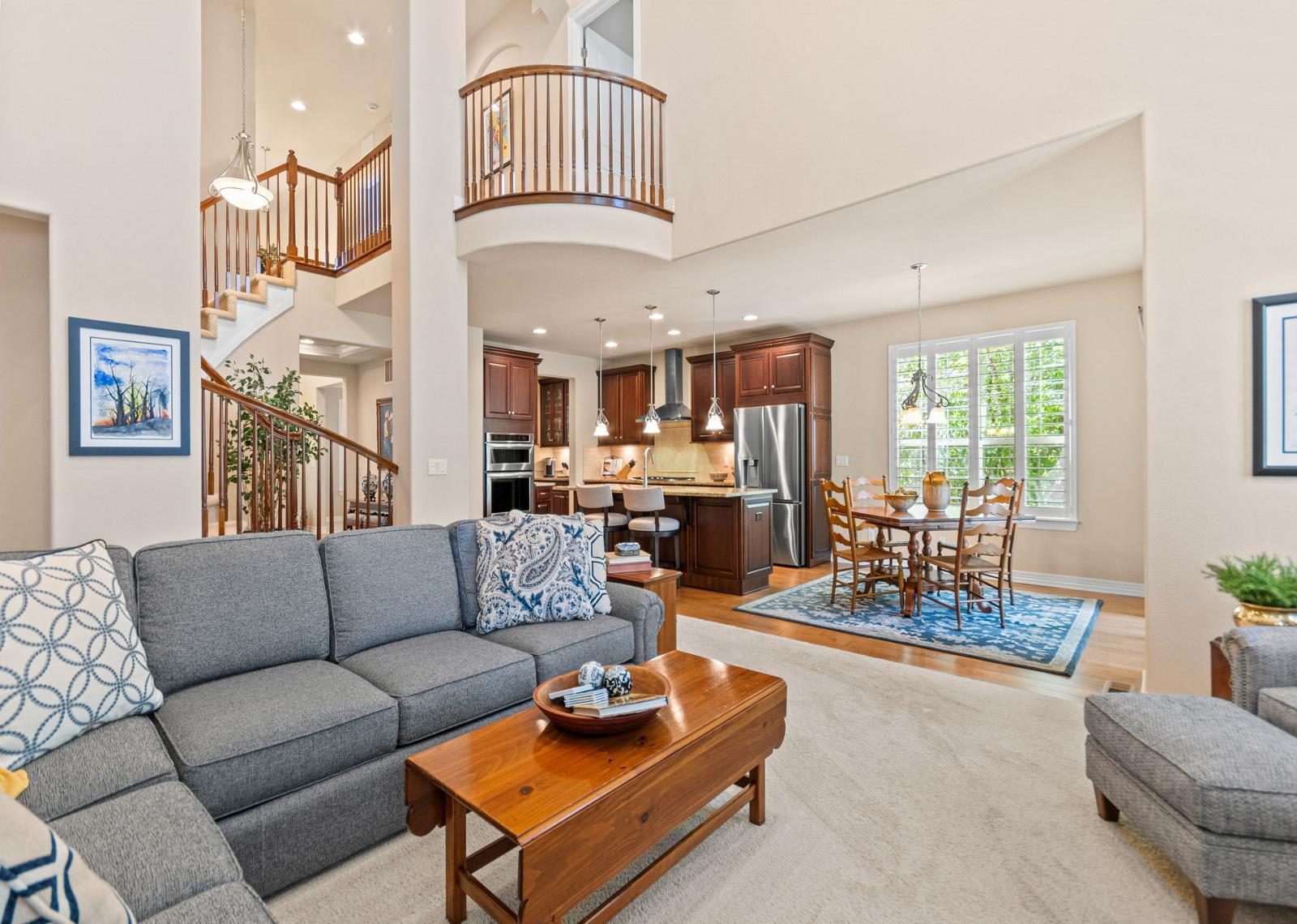 Two-story living room with a fireplace and a sectional sofa.