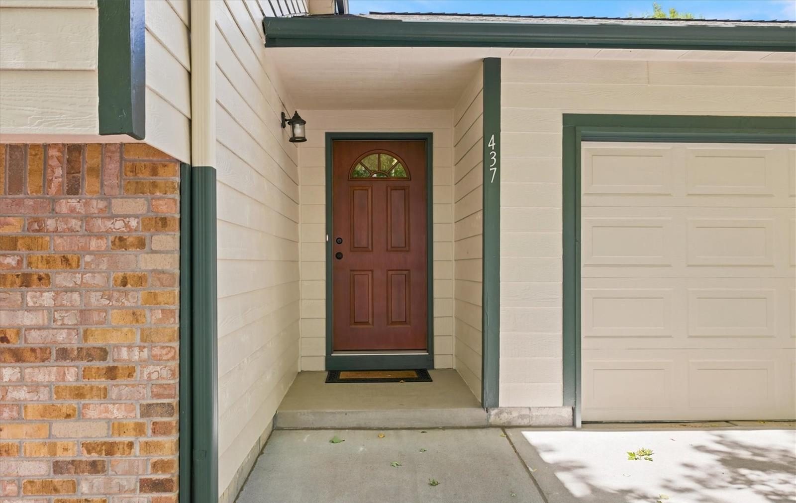 Front door with a brick surround at a central Broomfield home.