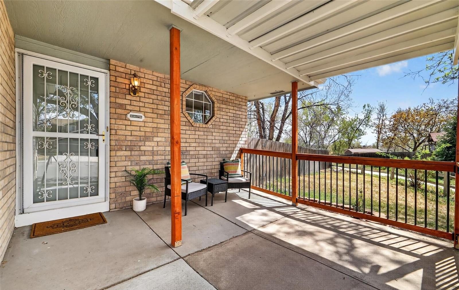 Covered back patio of a brick home in central Broomfield.