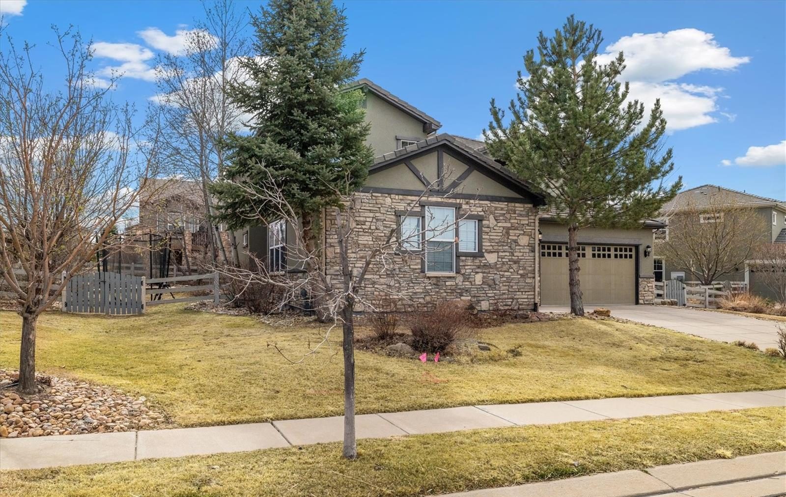 Two-story home with stone accents and a front lawn.