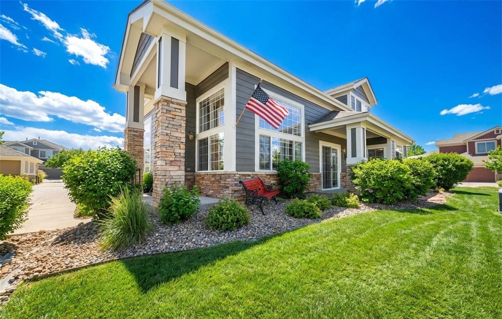 Townhome with a covered entry and a flag.