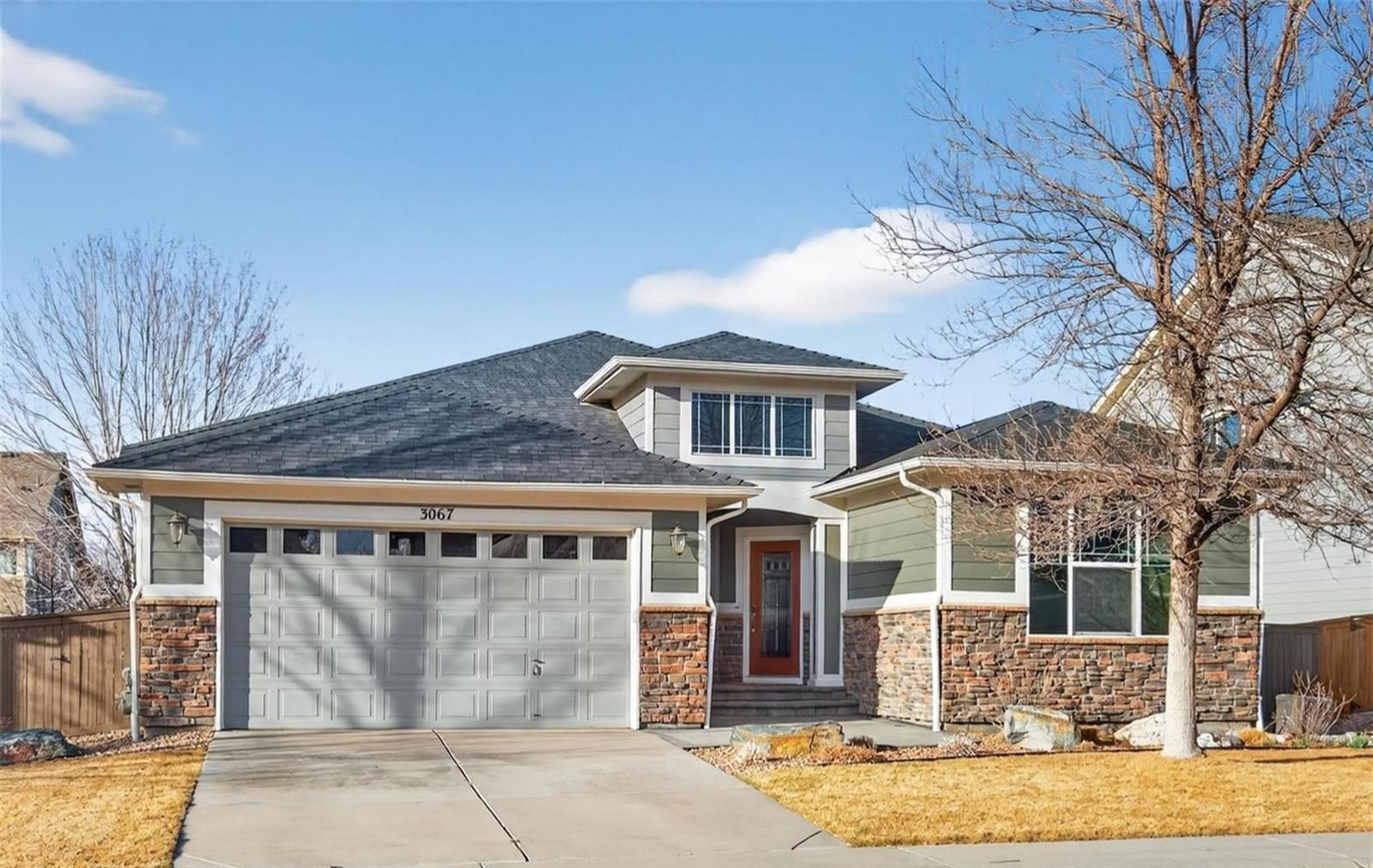 Craftsman ranch home with a stone base in Thornton.