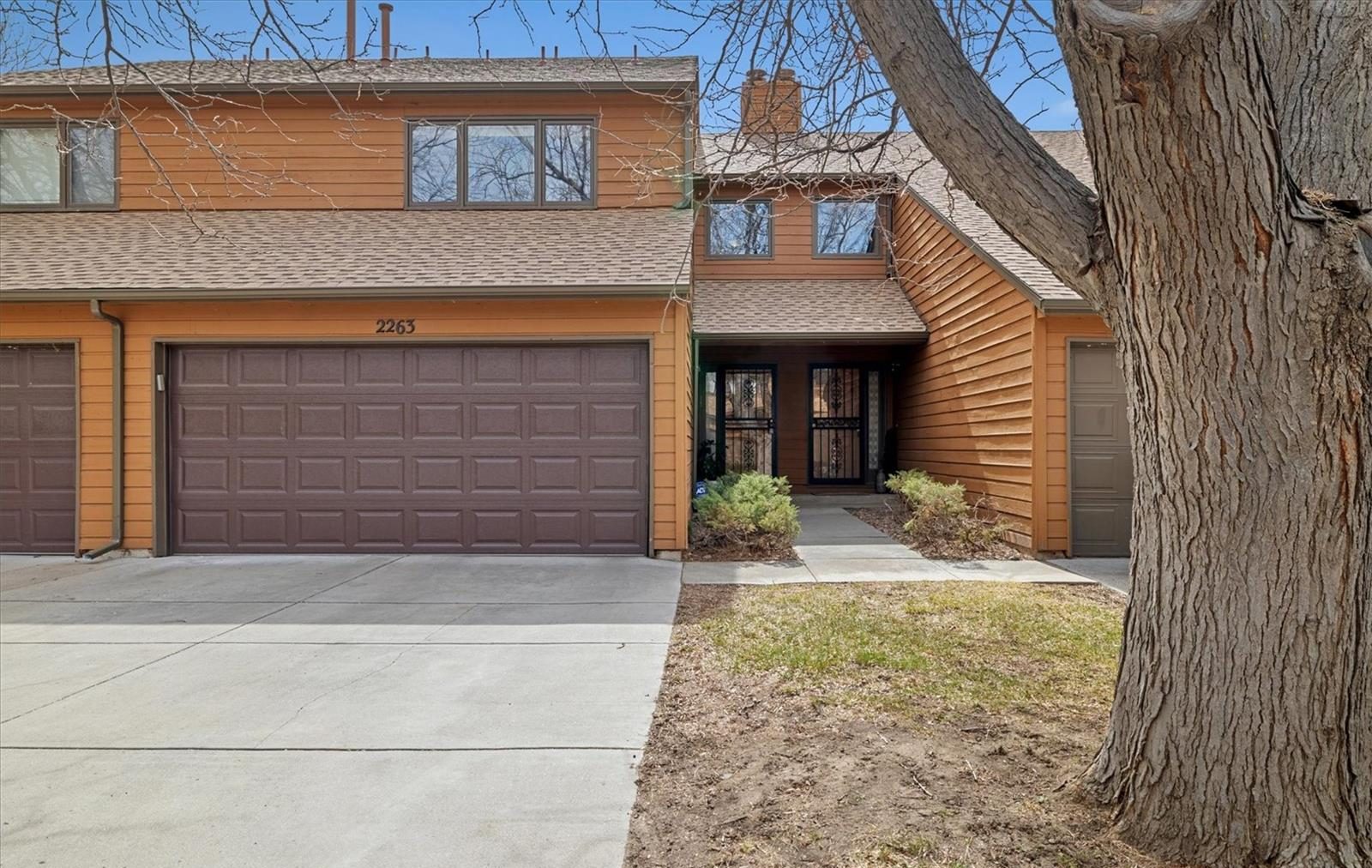 Two-story home with a big shade tree in Thornton.