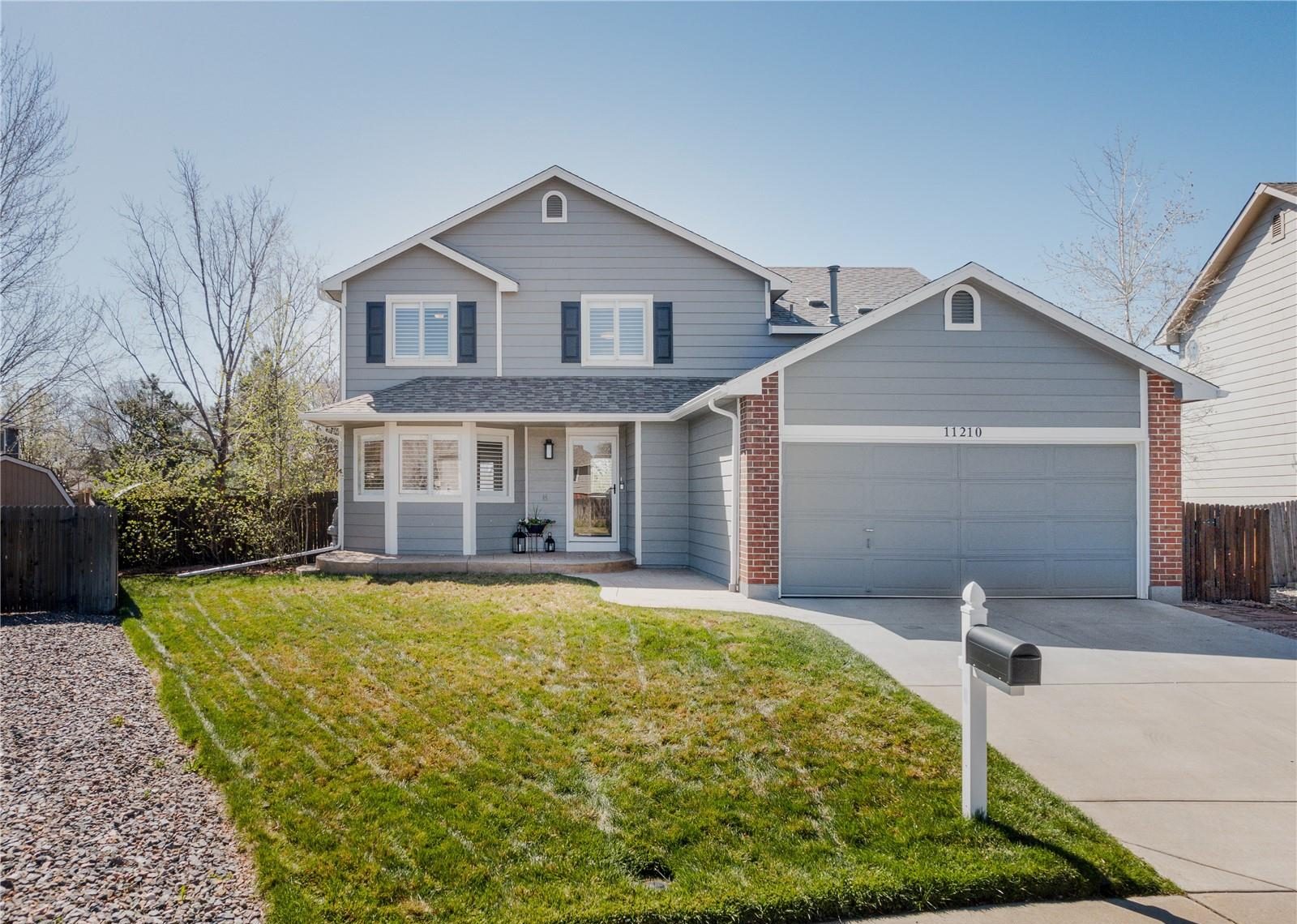 Gray two-story home with a front lawn in Westminster.