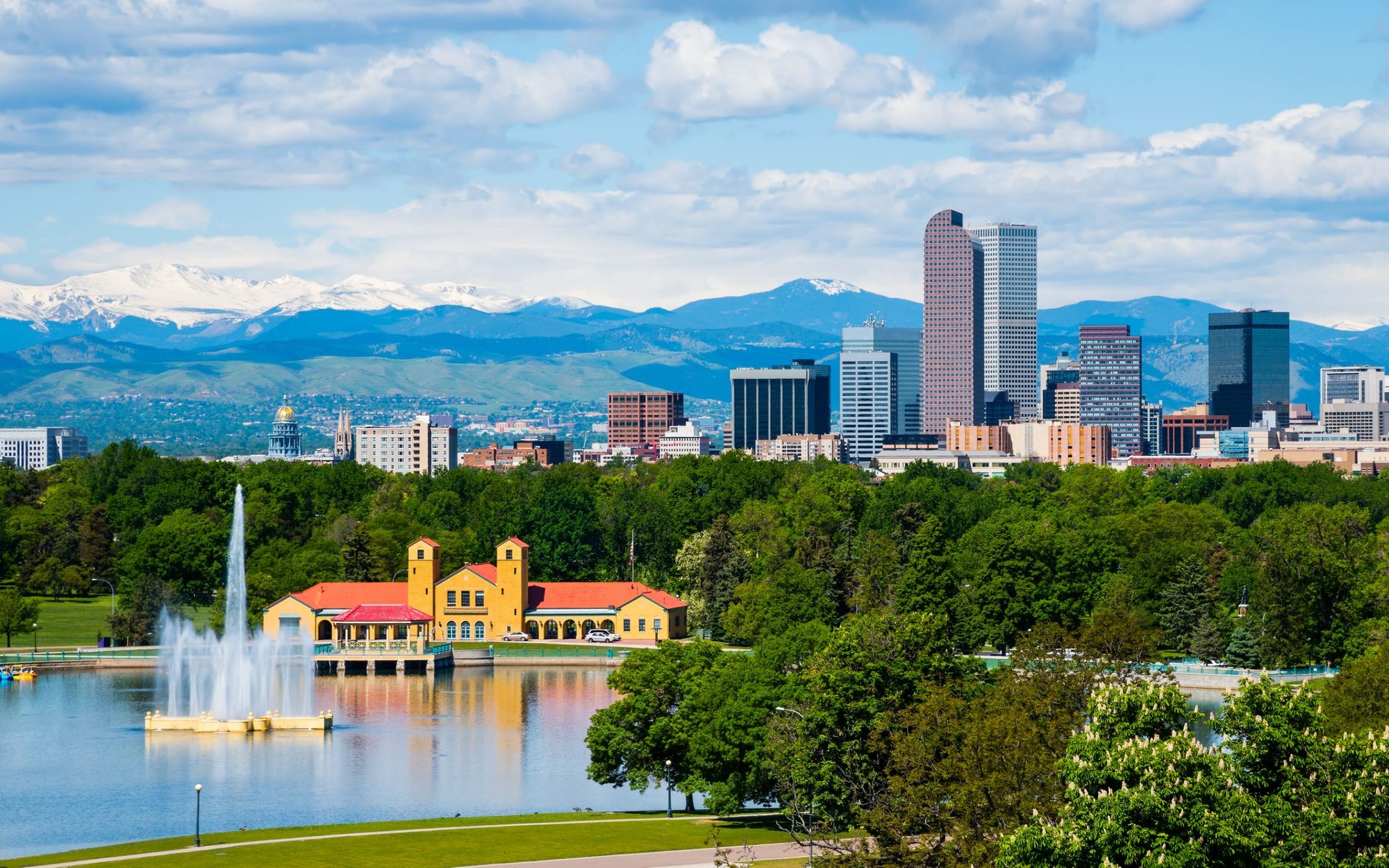 Denver skyline and the Front Range above City Park and Ferril Lake.