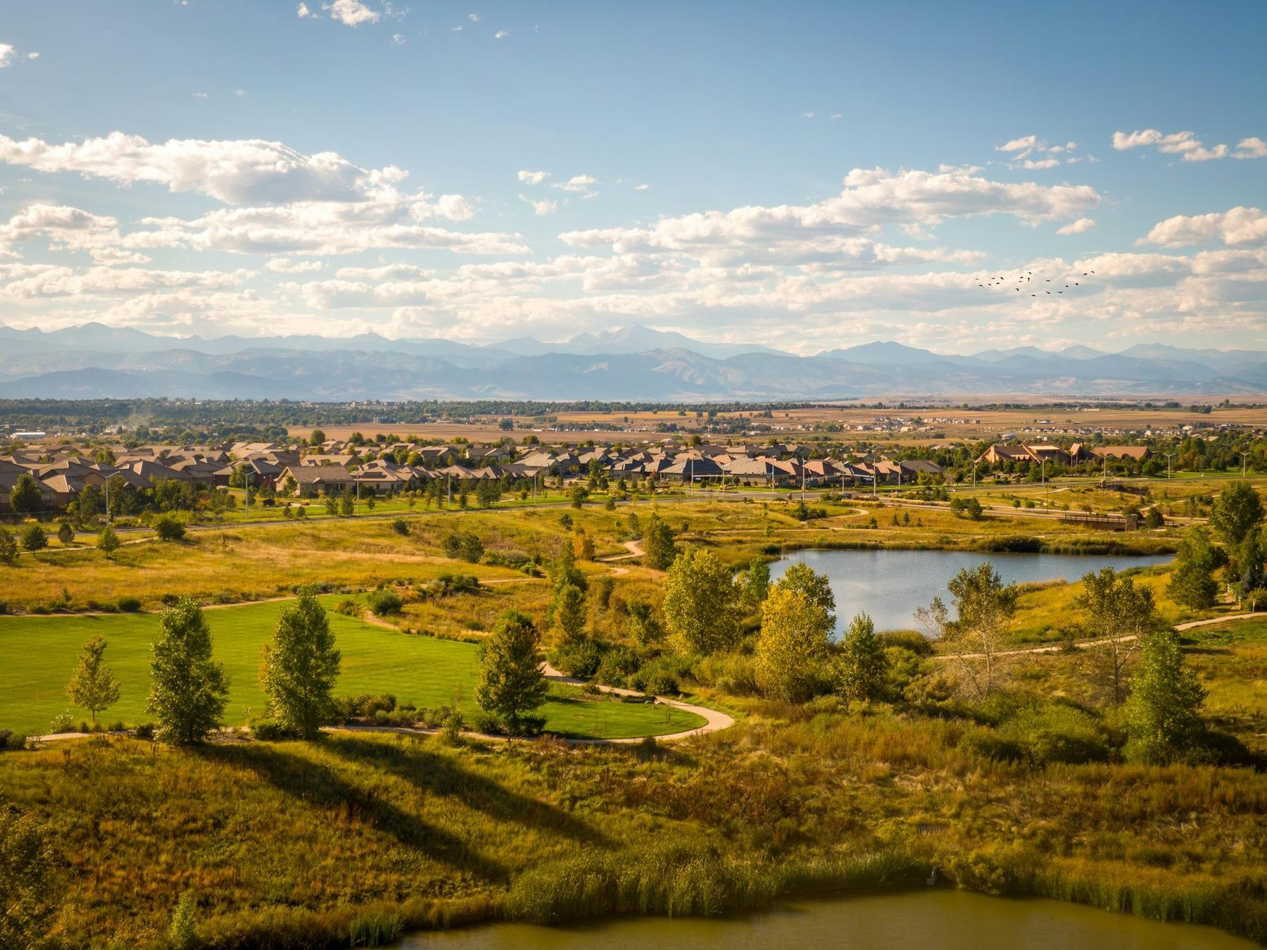 Golf course and pond near Broomfield, with the Front Range beyond.