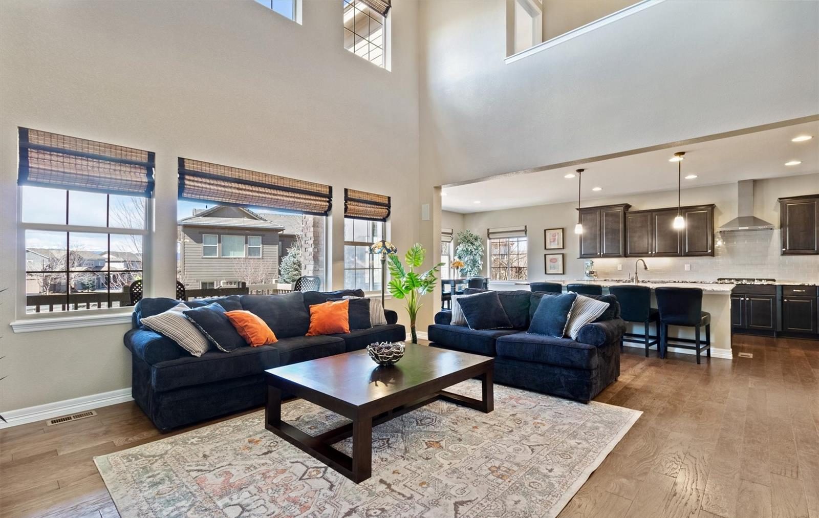 Open great room and kitchen with tall windows in an Anthem Highlands home.