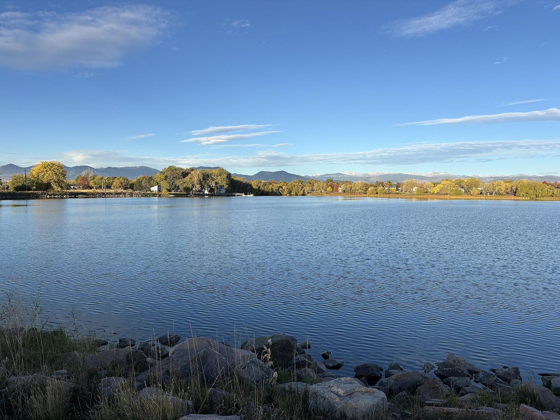 Waneka Lake in Lafayette on a clear day, with the Front Range on the horizon.