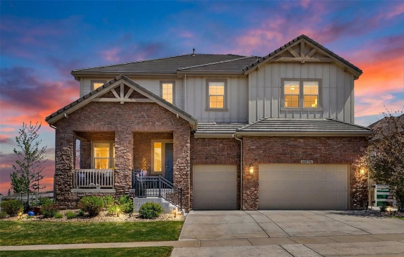 Two-story home on Swan Mountain Drive in Broomfield at twilight.