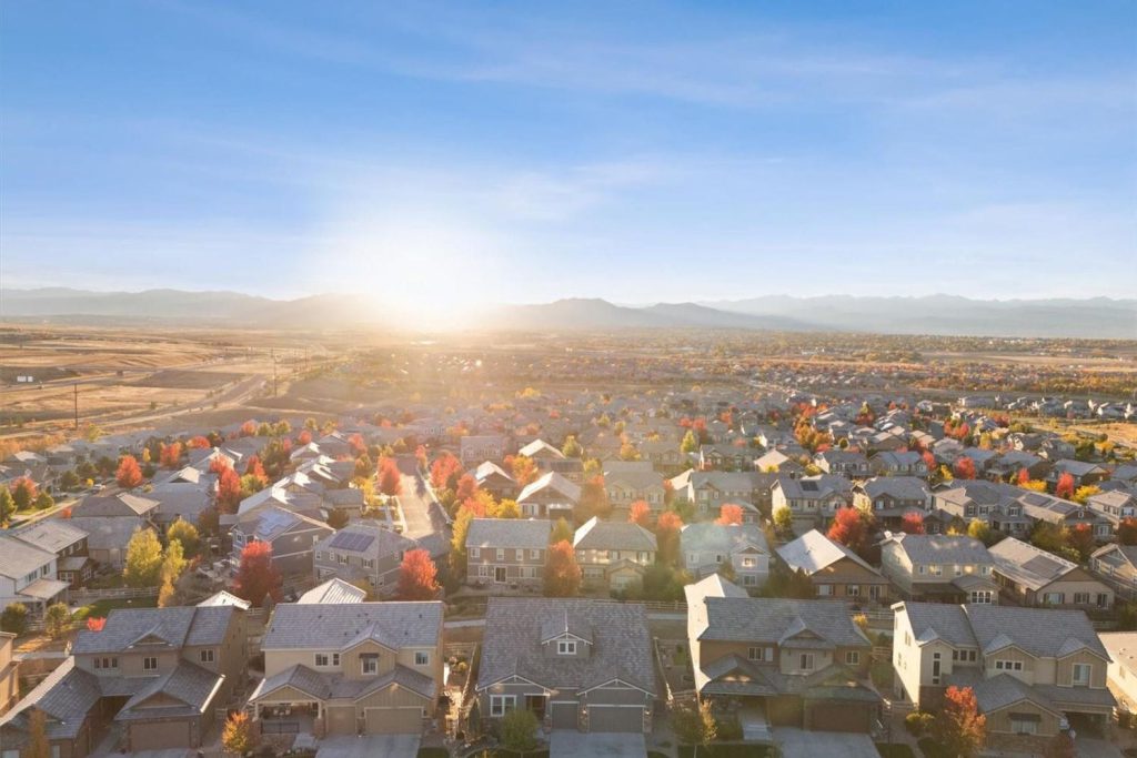 The sun setting over the rooftops of Anthem Highlands and the Front Range.