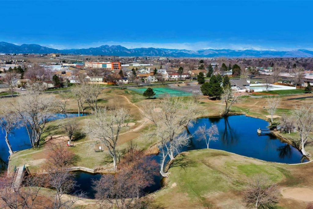 Aerial view of ponds and open space near Greenway Park, with the Front Range beyond.