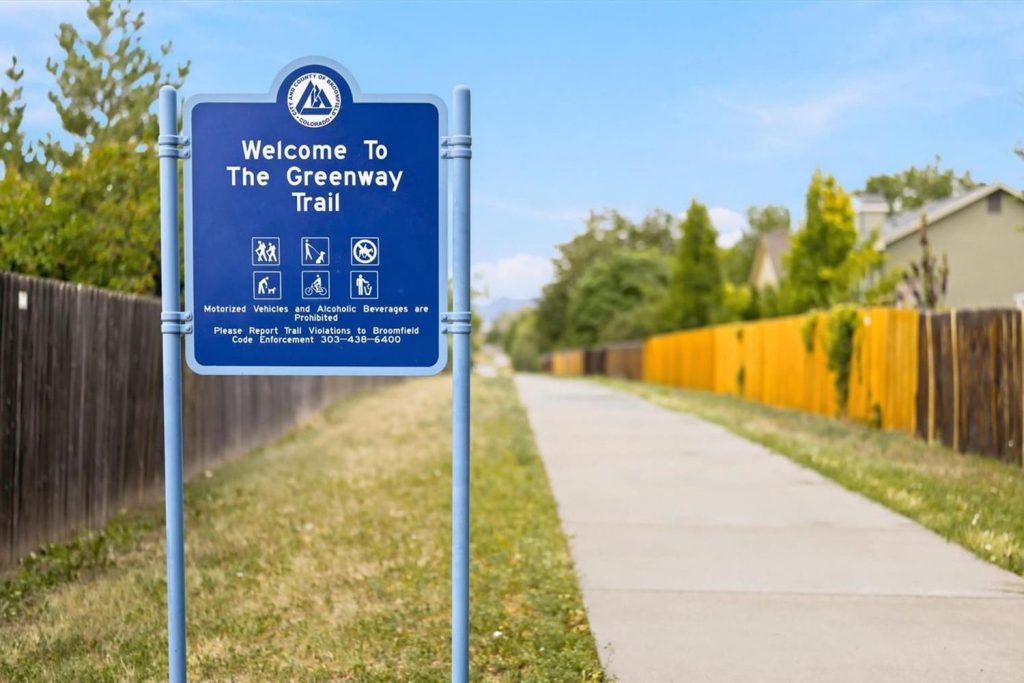 A Greenway Trail sign beside a paved path in Broomfield.