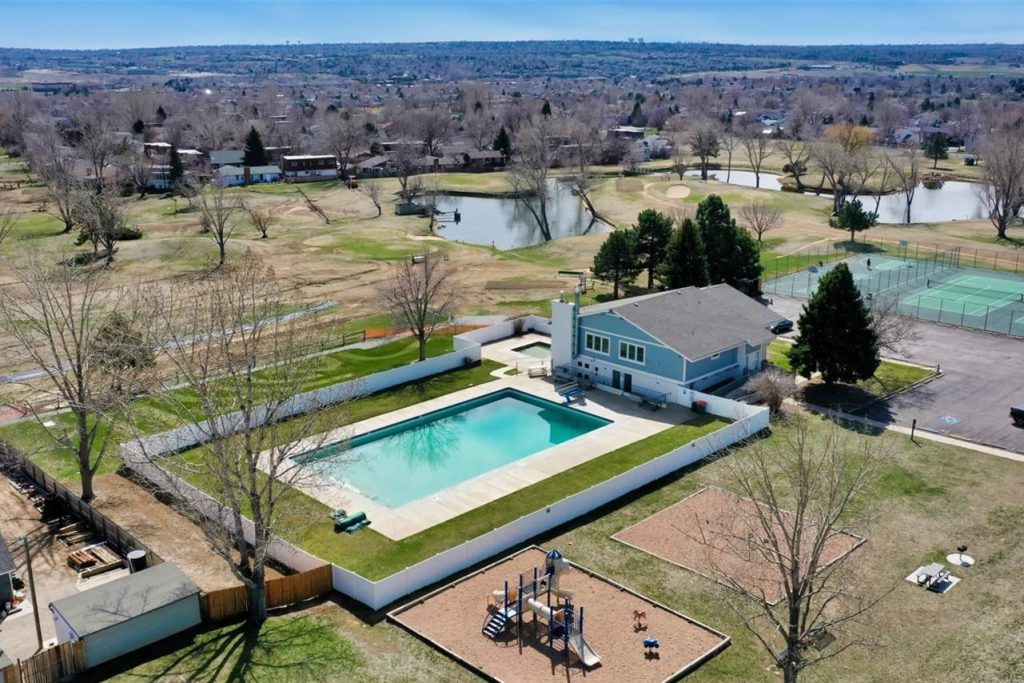 Aerial view of a neighborhood pool and tennis courts in Greenway Park.