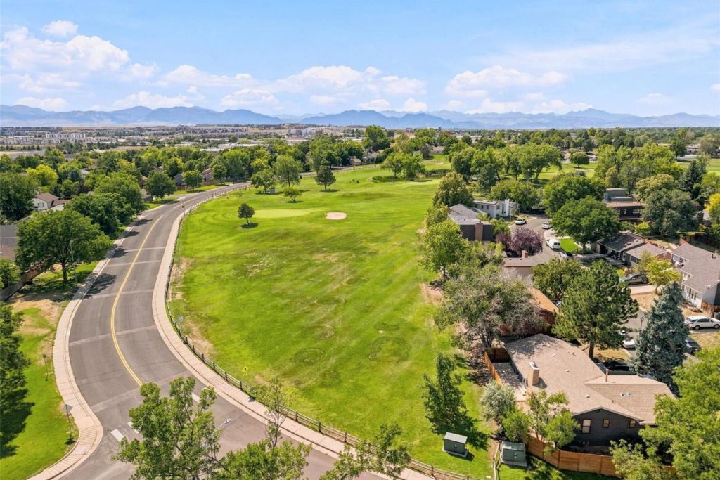 Aerial view of the golf course in Greenway Park, with the Front Range beyond.