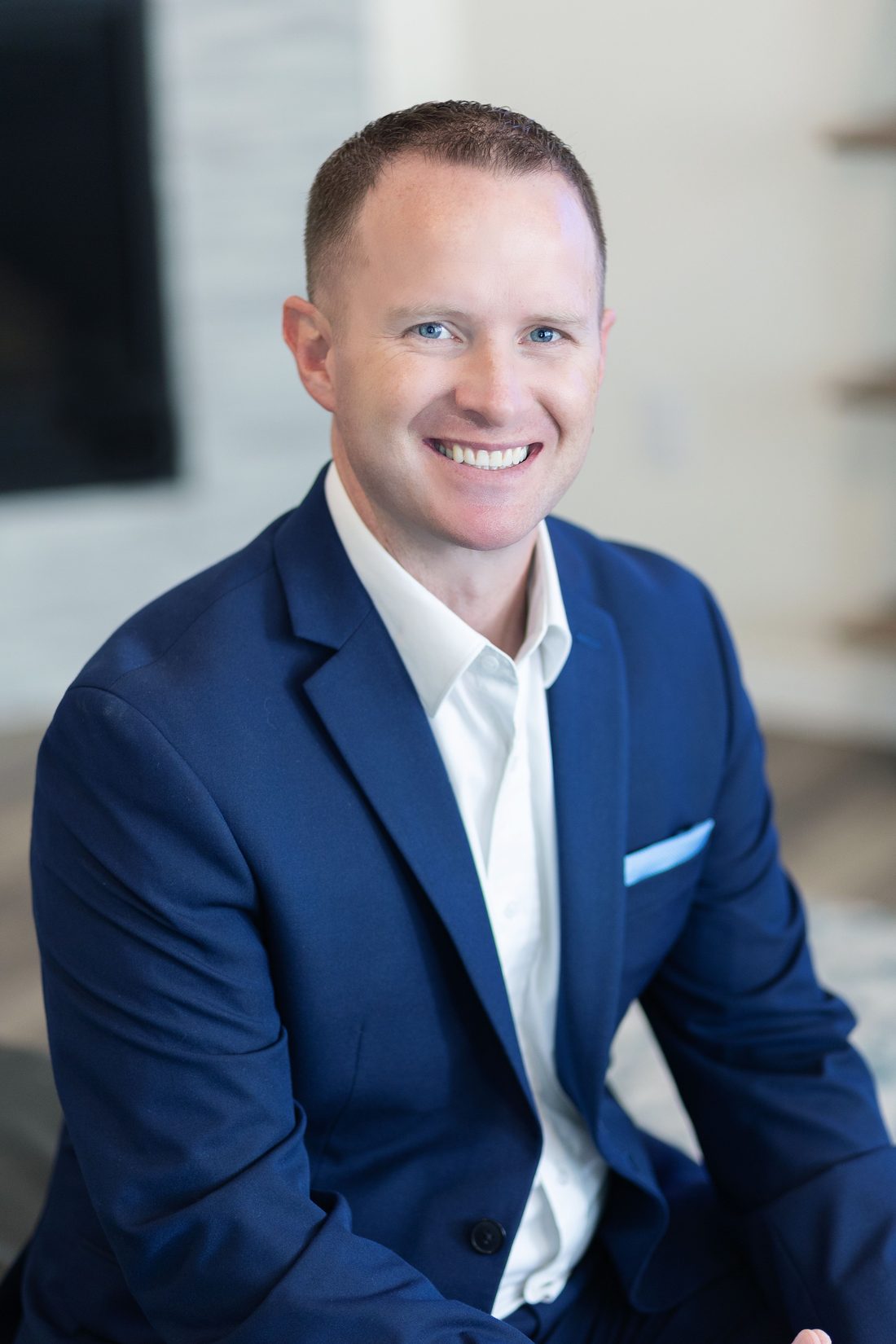 Portrait of Steve Calley in a navy blazer and white shirt, smiling.