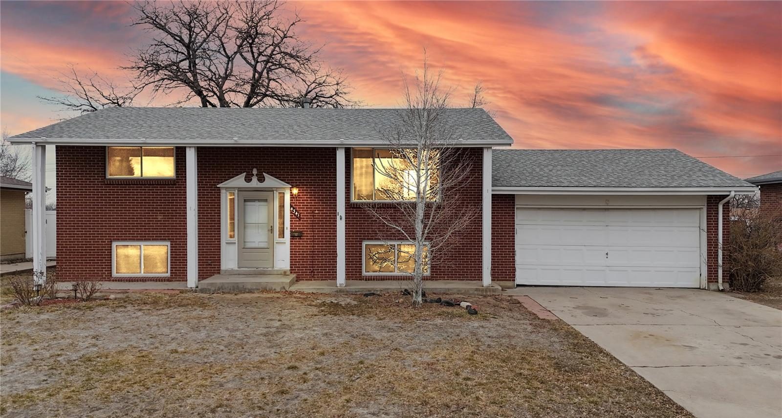 Brick bi-level home in southwest Denver at sunset.