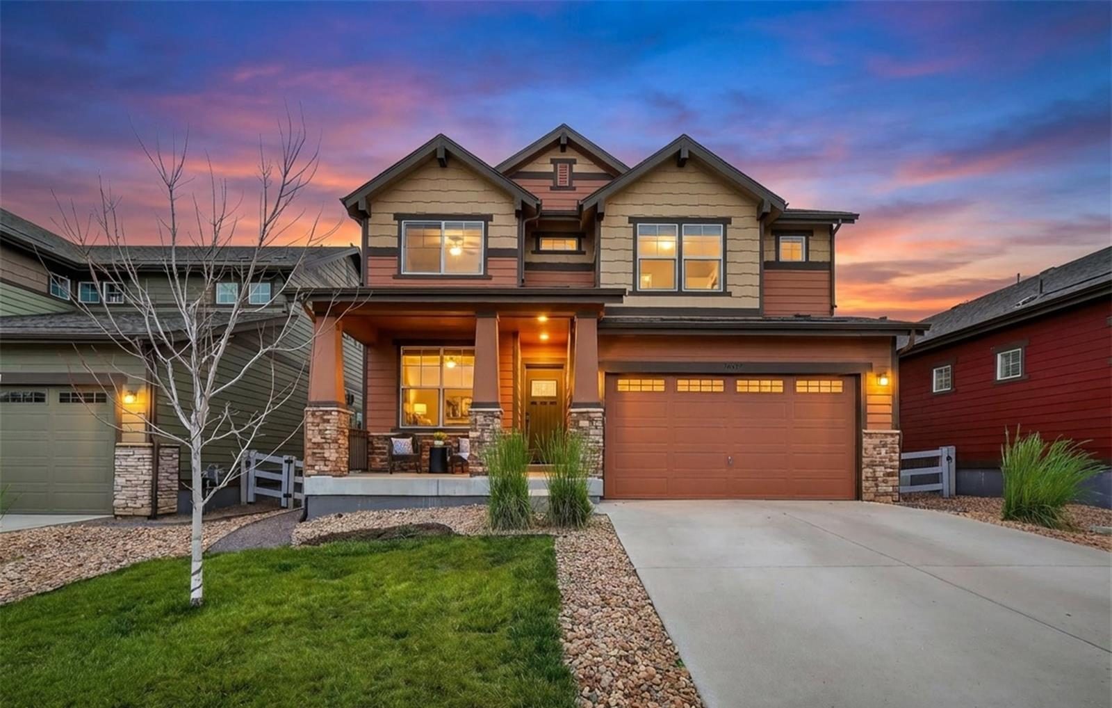 Two-story craftsman home in Anthem Highlands, Broomfield, lit up at twilight.