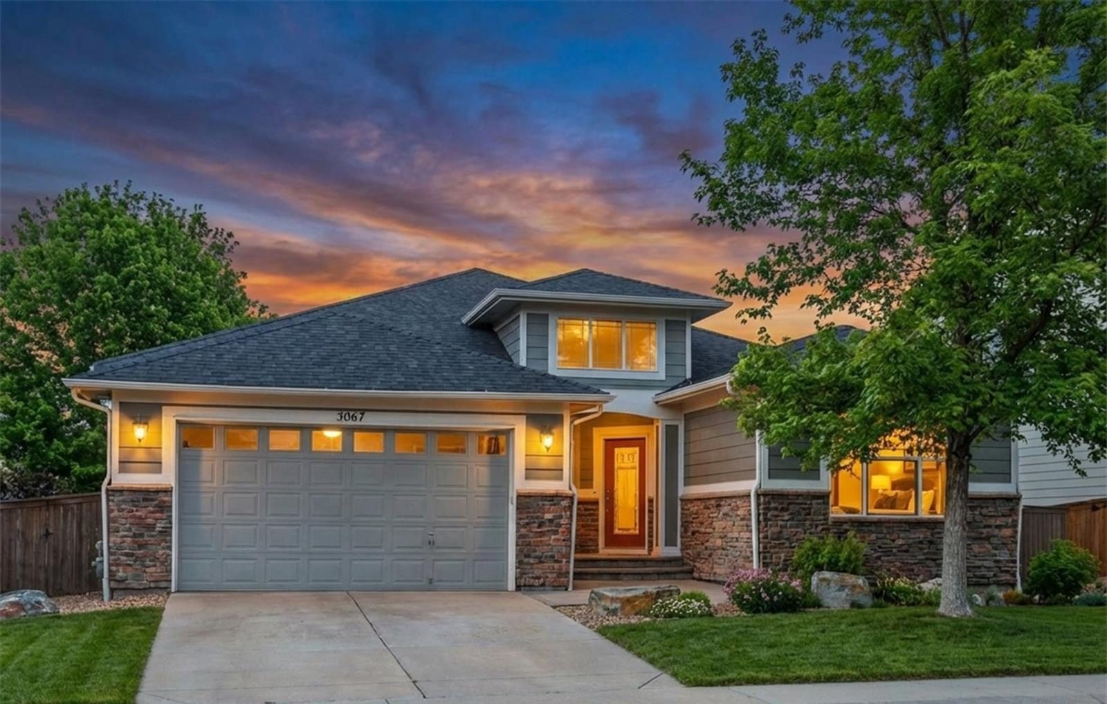 Ranch-style home in Thornton at dusk with warm light in the windows.