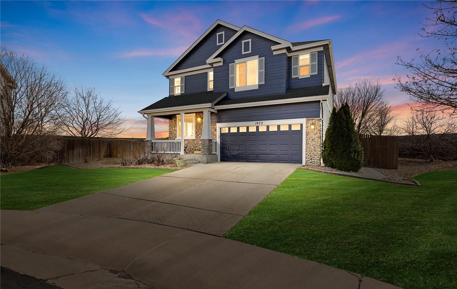 Navy two-story home in north Thornton at dusk.